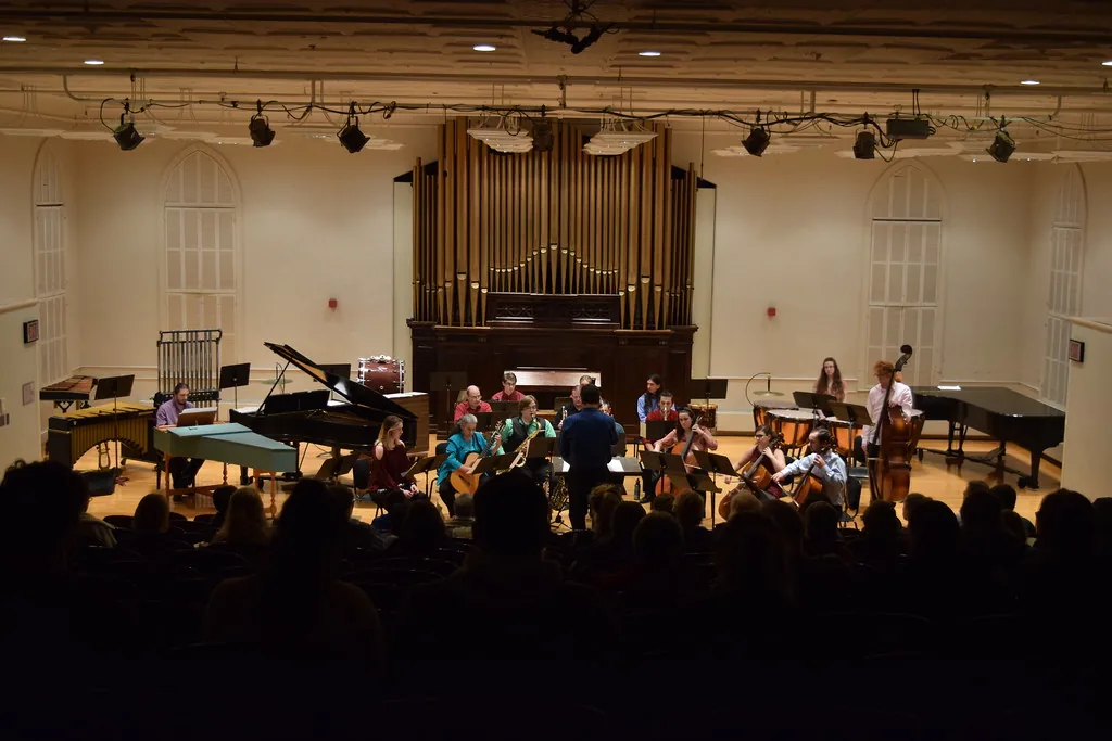 Composer conducting an ensemble of musicians Composer conducting an ensemble of musicians