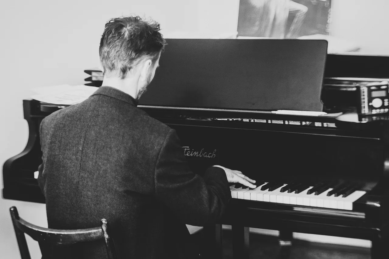 Musician playing a composition on the piano Musician playing a composition on the piano