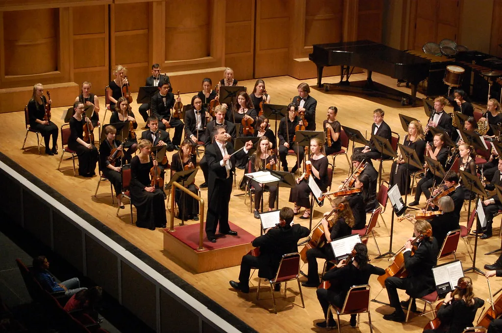 Conductor leading a large musical ensemble