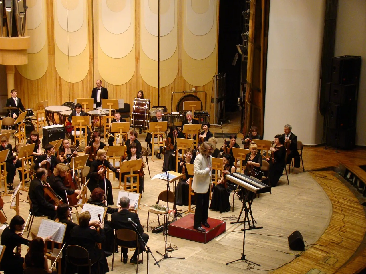 Conductor leading an orchestra in concert