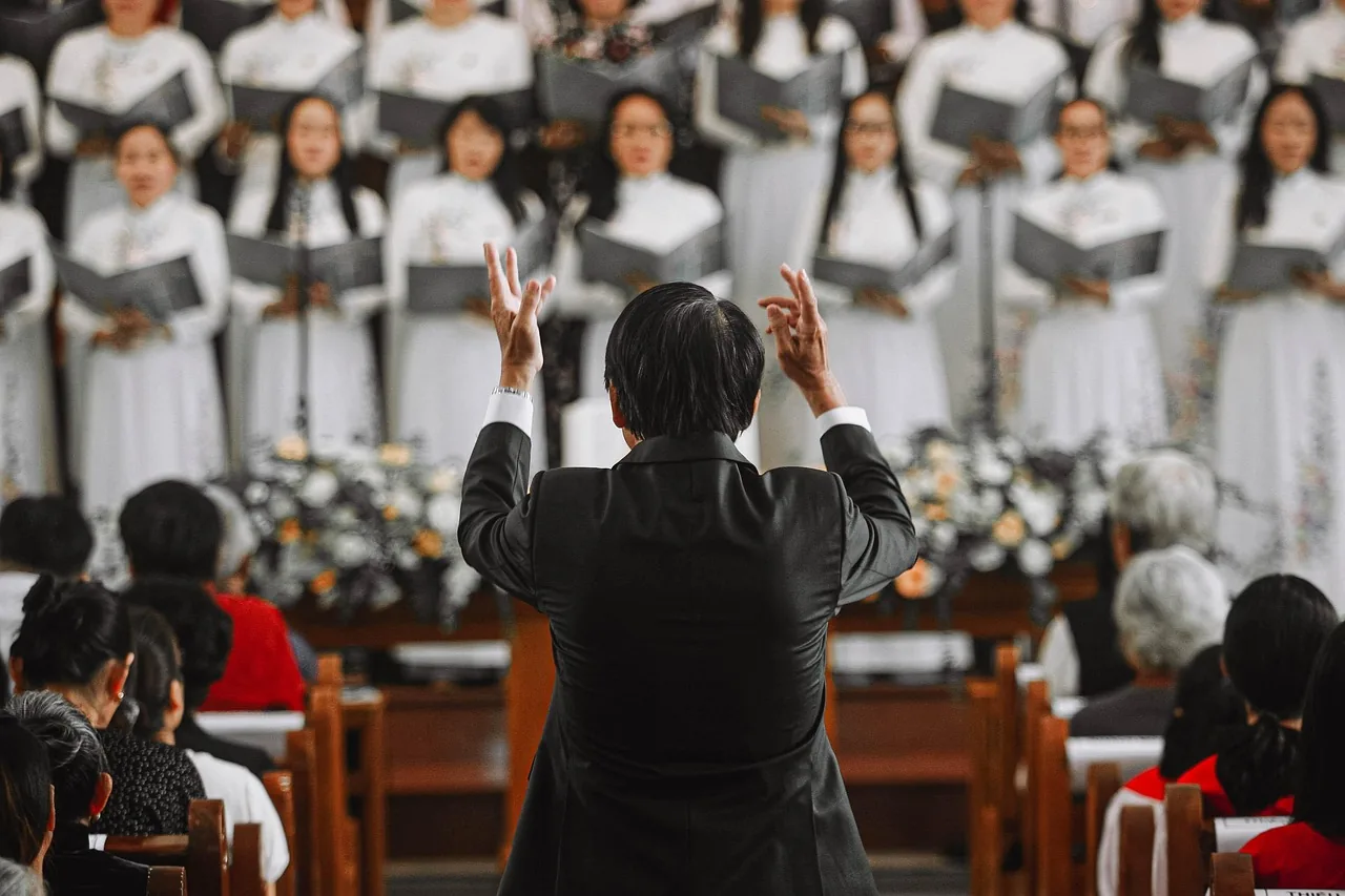 Choir conductor leading a musical rehearsal Choir conductor leading a musical rehearsal