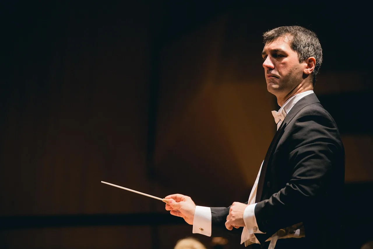 Young conductor leading an orchestra
