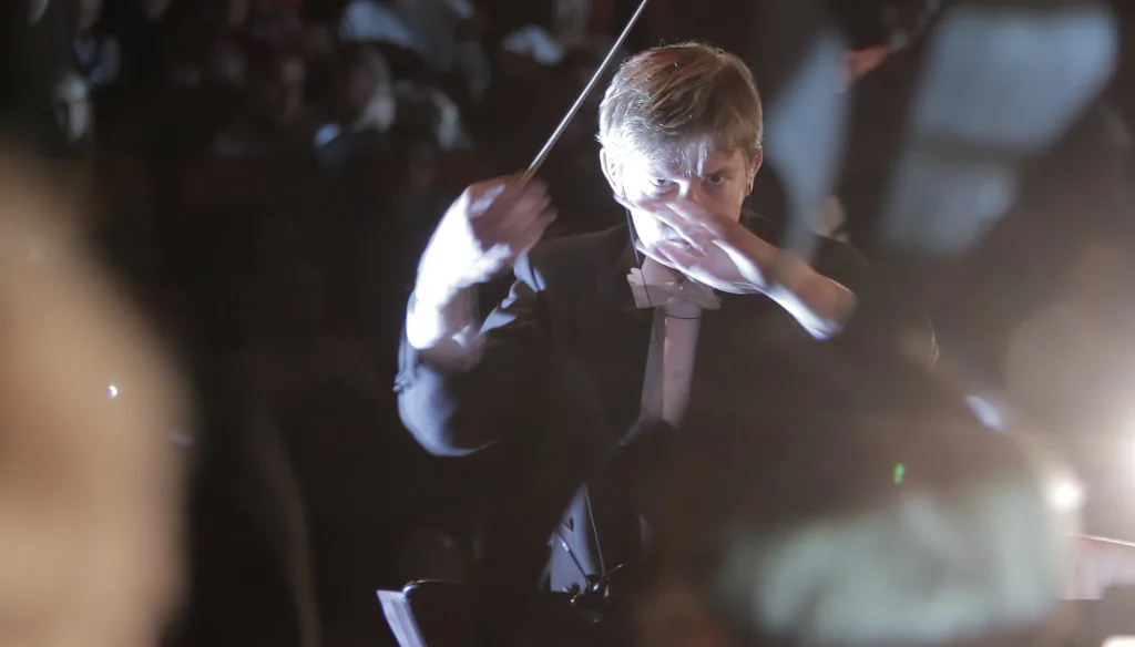 Conductor directing a modern concert Conductor directing a modern concert